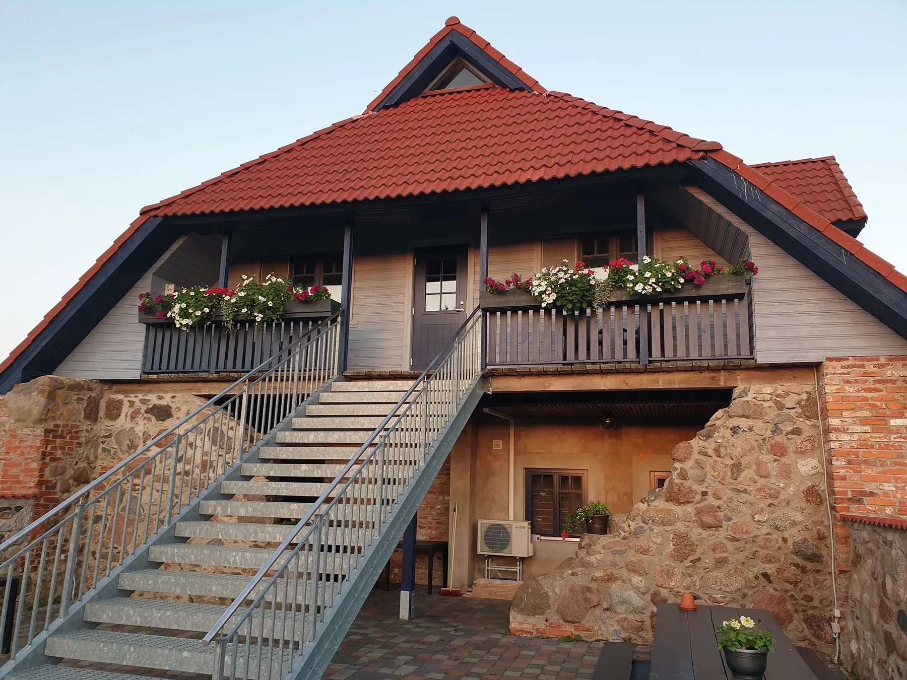 Balcony and stairs of the holiday house with flower boxes