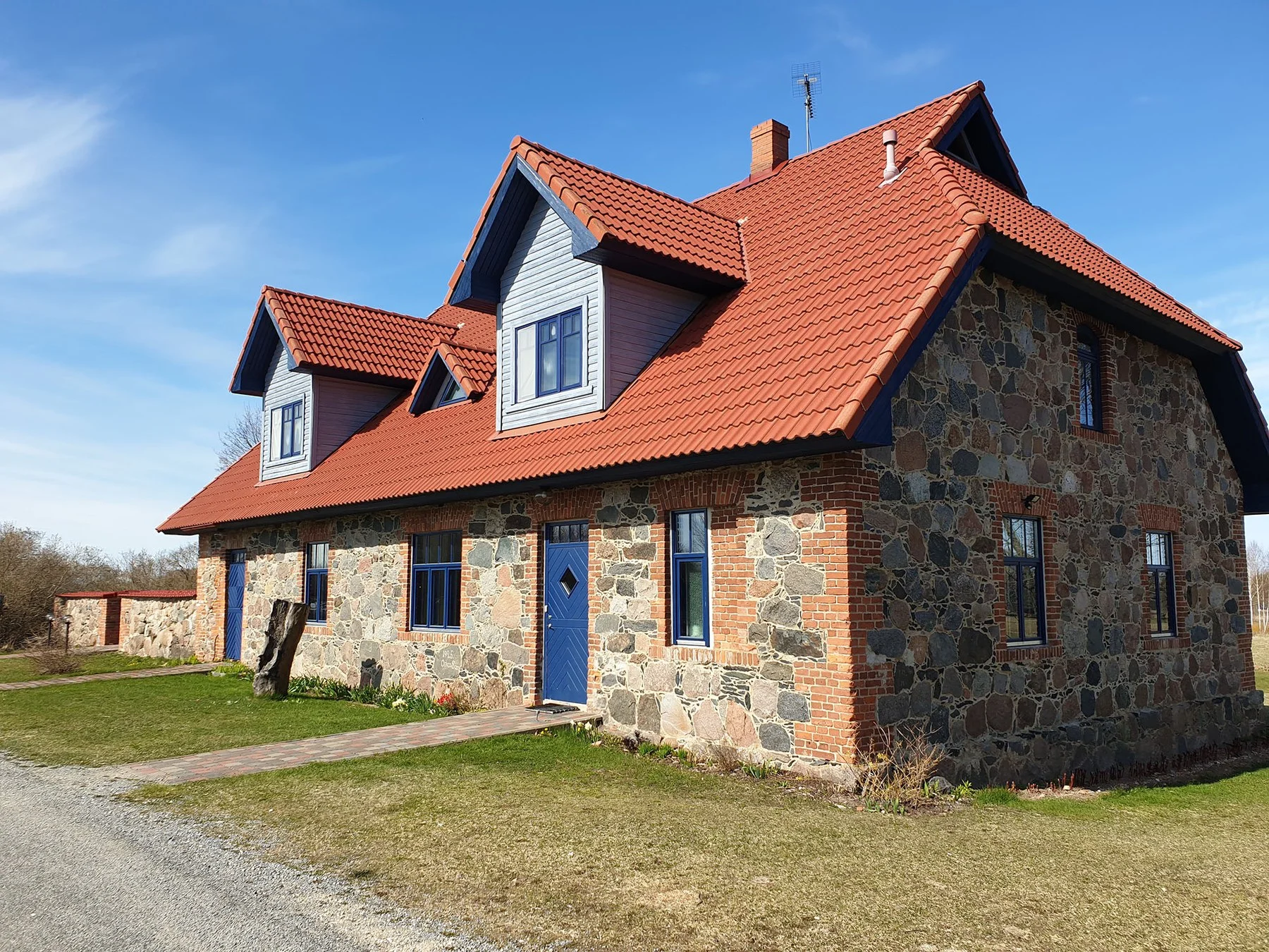 The fieldstone holiday house and a stone wall
