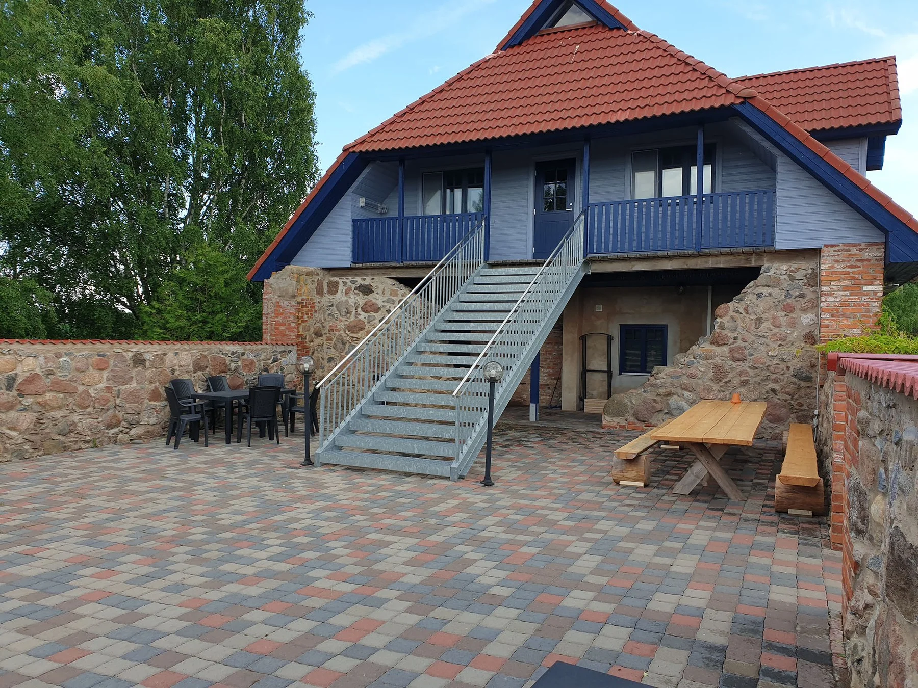 Holiday house terrace with garden furniture and a picnic table