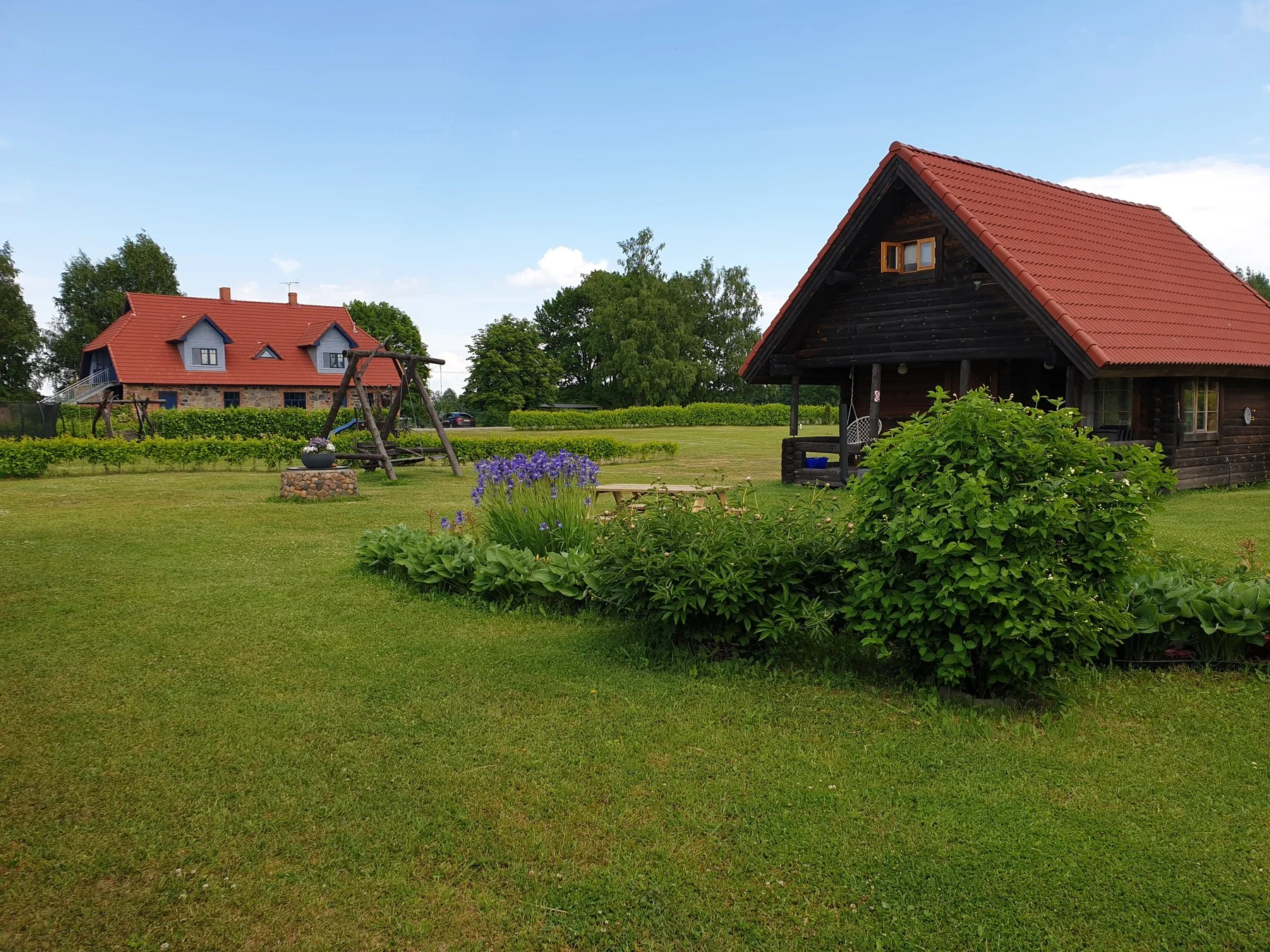 The sauna house and holiday house on a wide lawn