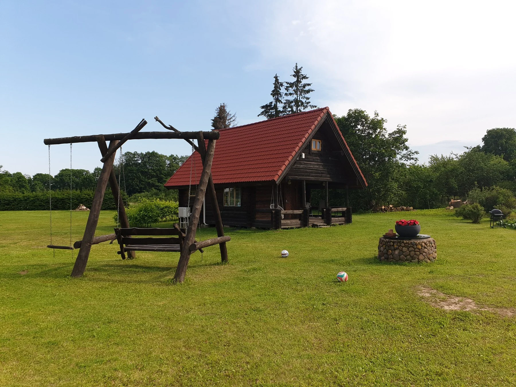 Swing and sauna house in the summer yard