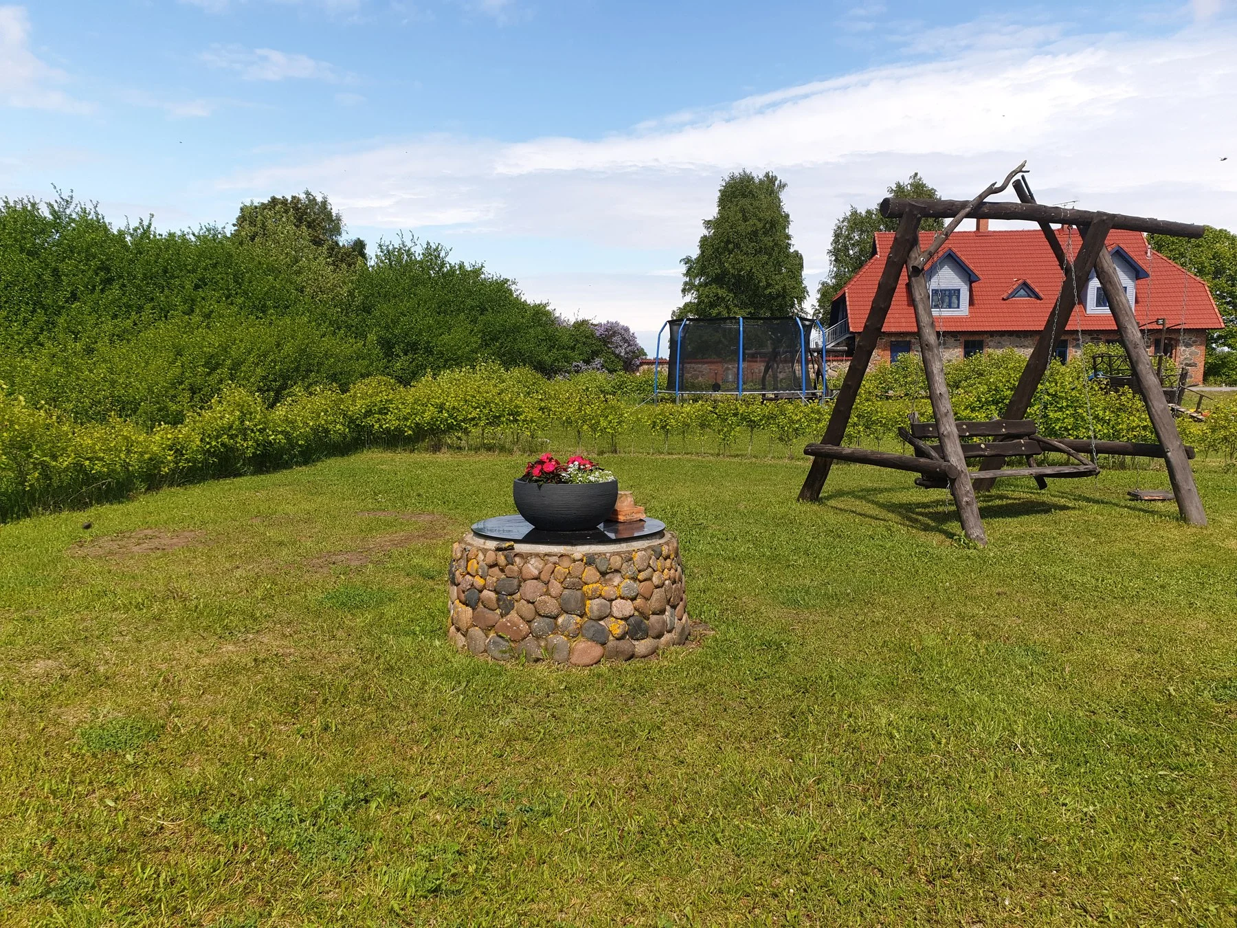Campfire site and swing on the holiday village lawn