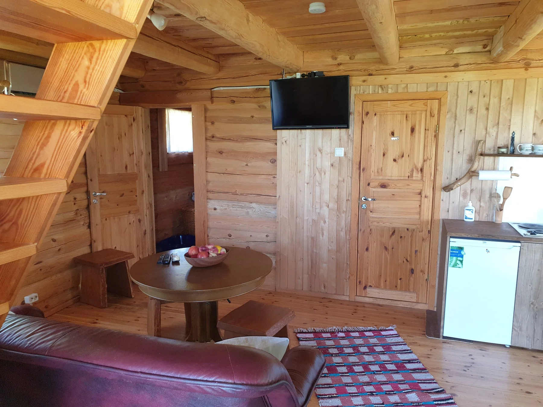 Living room with a TV, sofa and dining table