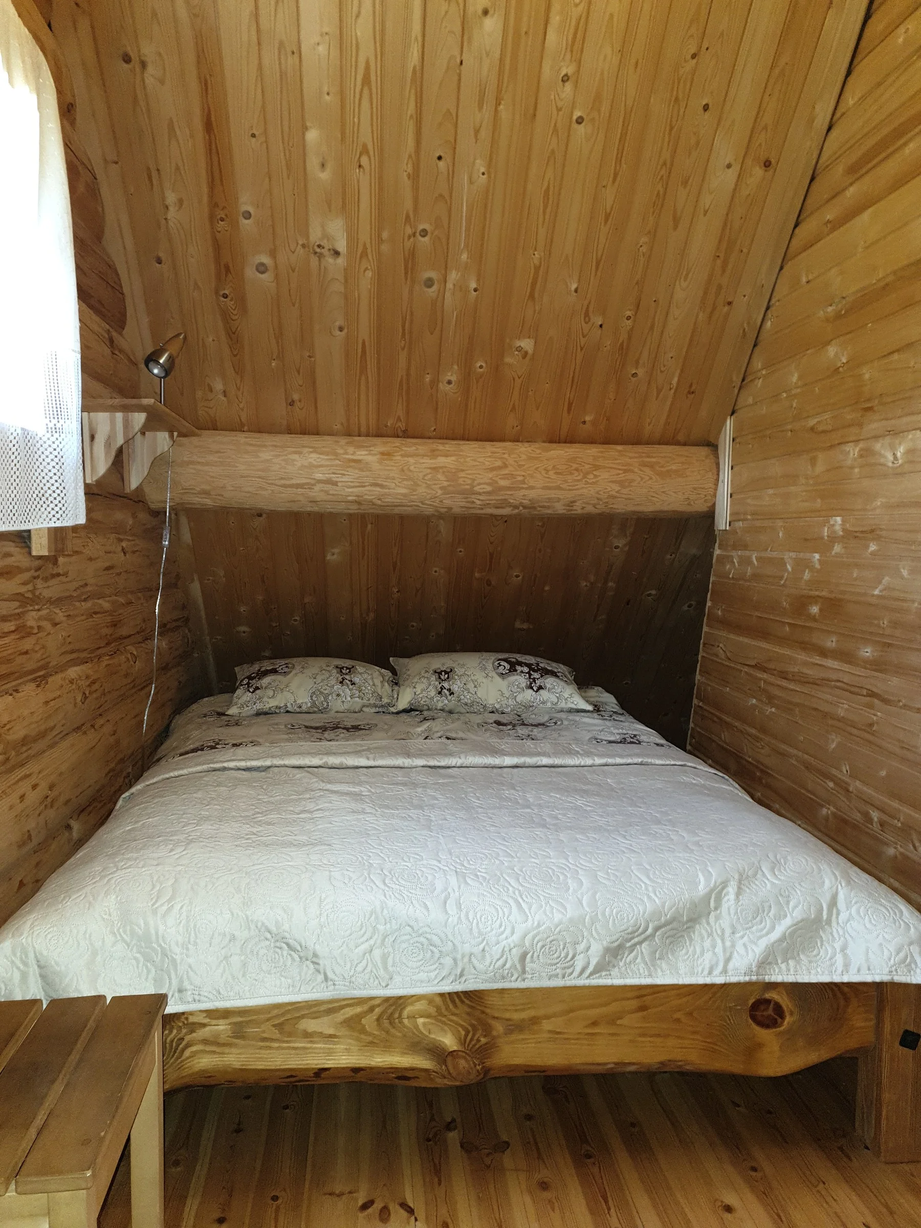 Double bed under a sloping ceiling