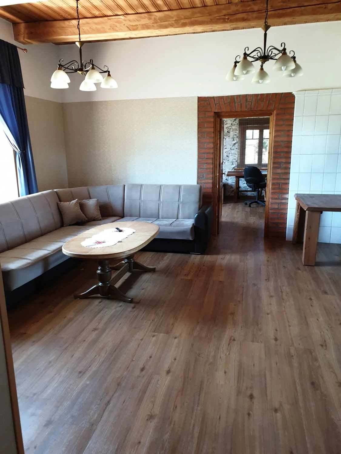 Spacious living room with sofas and a dining table