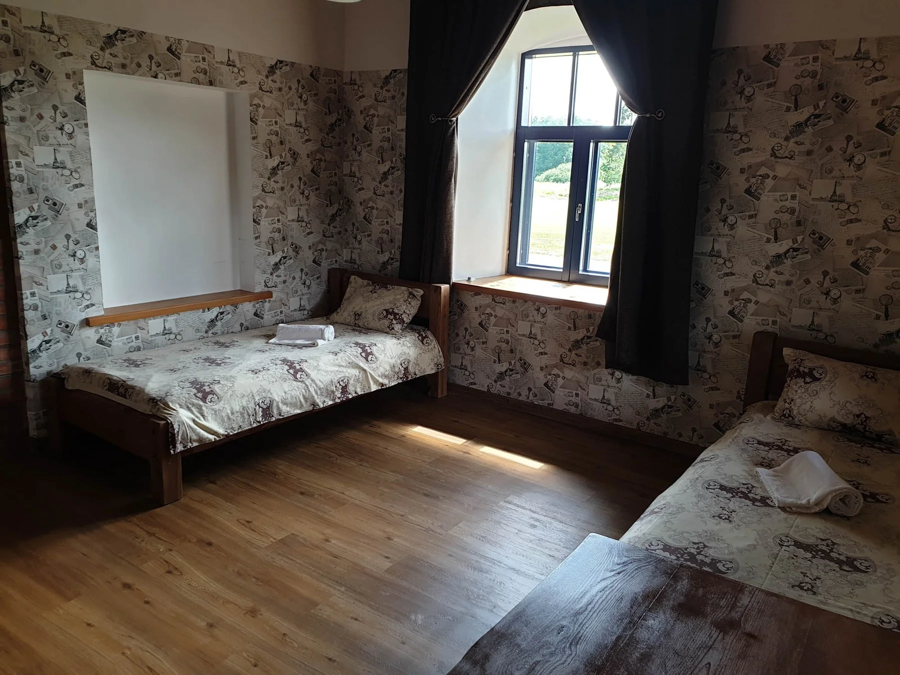 Bedroom with two beds and a fieldstone wall