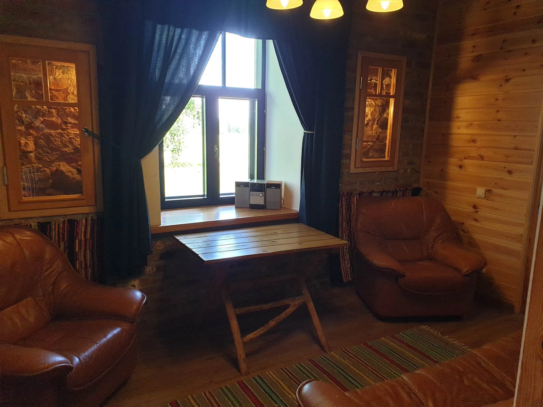 Lounge with log walls and armchairs