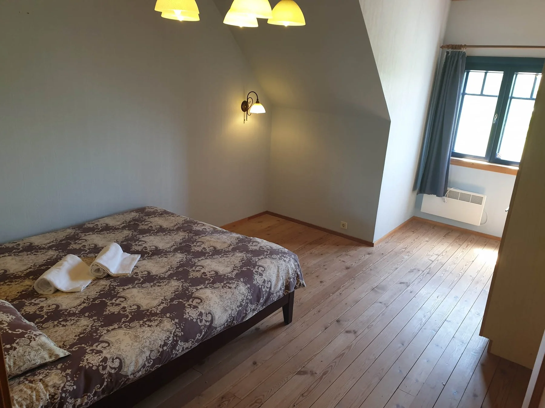 Bedroom with a double bed and wooden floor